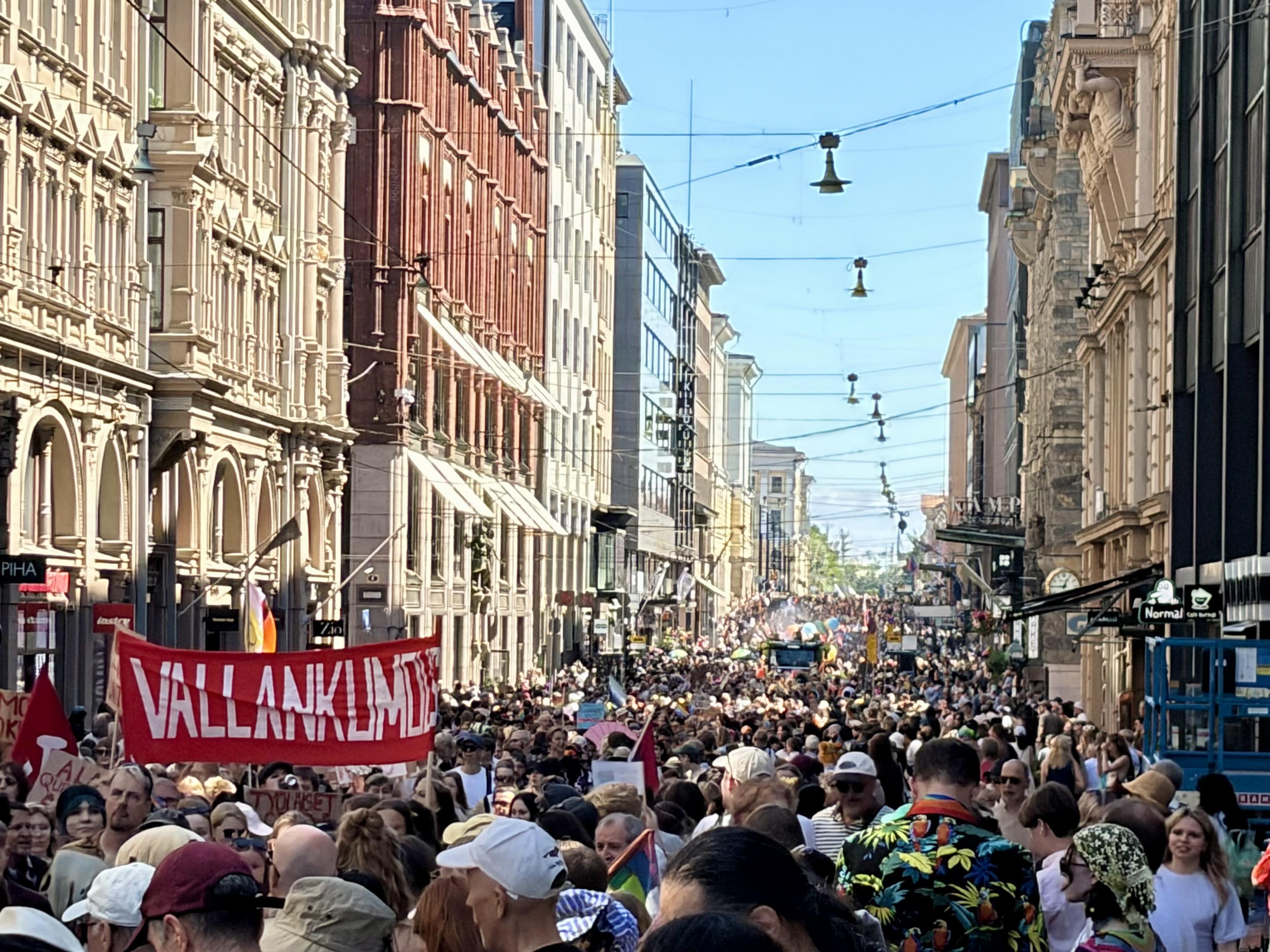 A huge parade stretching into the distance down a city street